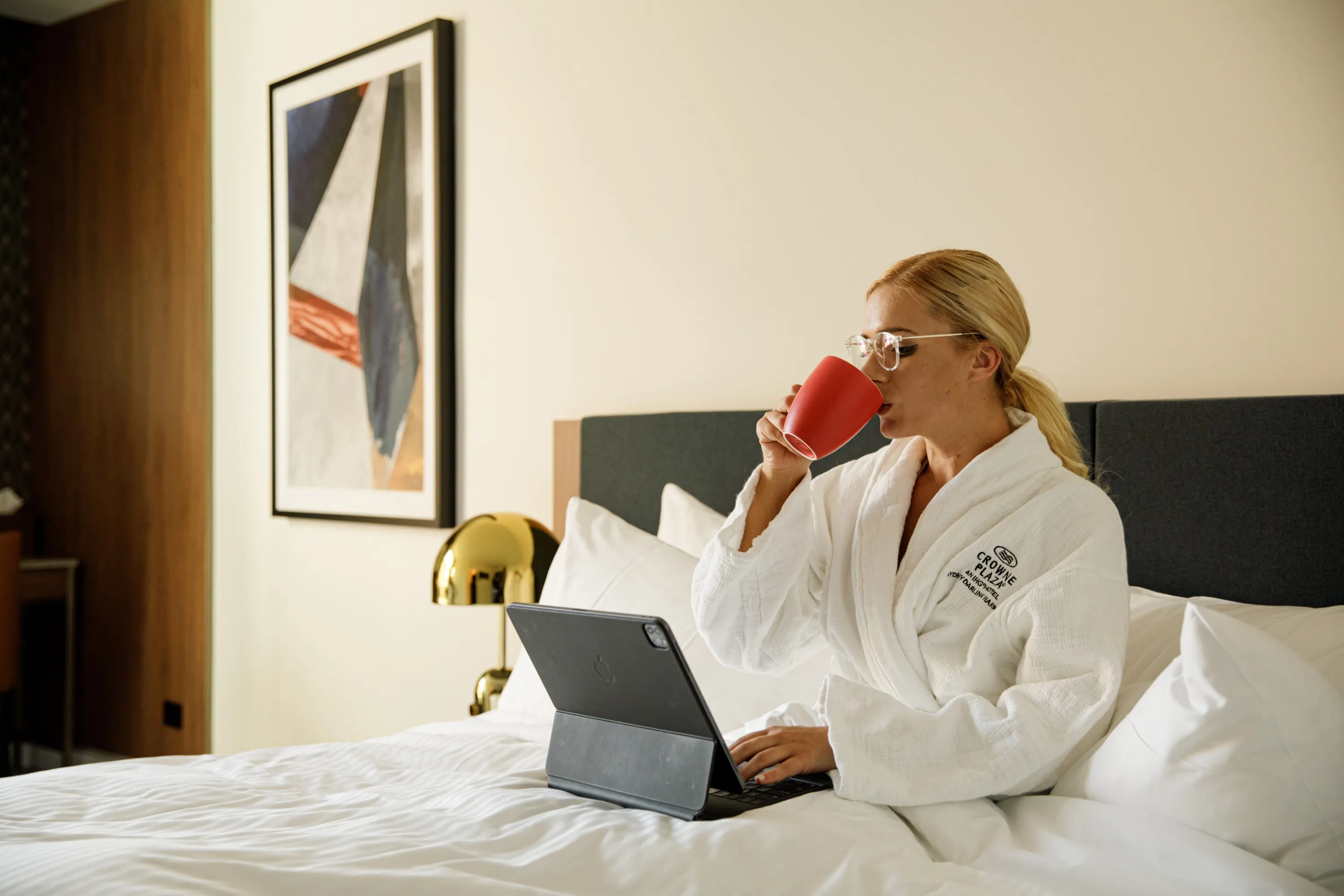 Lady working in bed at hotel