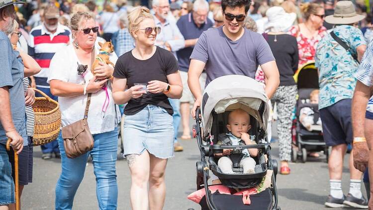 Families enjoying a stroll through the festival grounds.