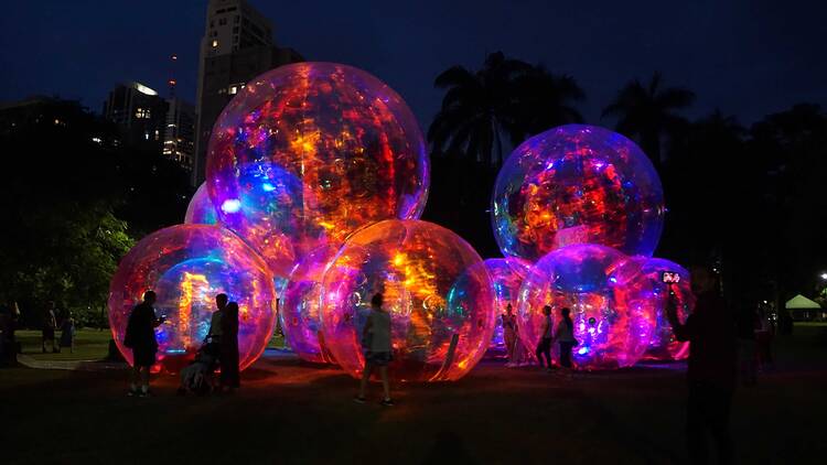 A large glowing art installation made up of giant spheres. 