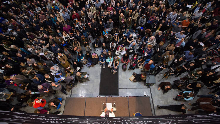 People gather around a performer at Brooklyn Public Library.