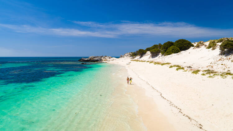 Aerial view of couple walking along the beach at Longreach Bay, Rottnest Island