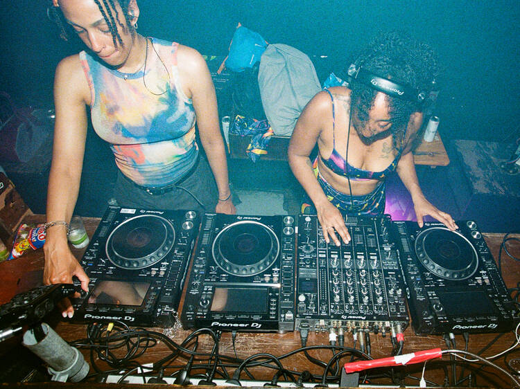 Two DJs playing decks