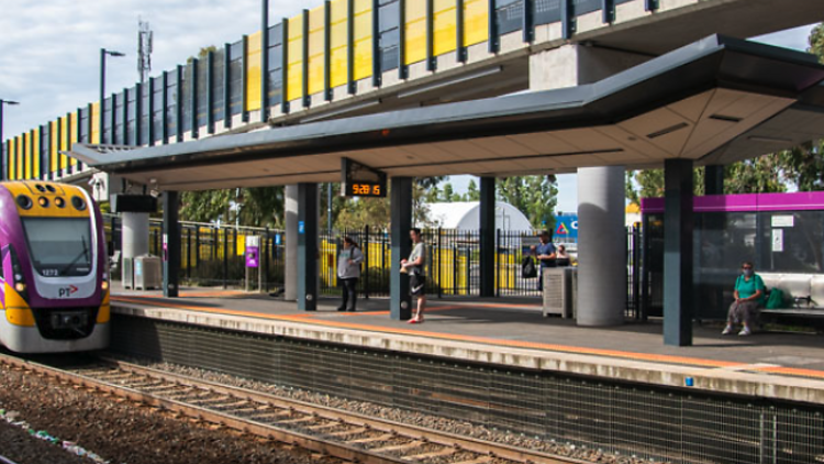 A train station with a V/Line train at the platform. 