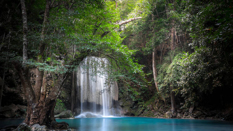 Swim in the multi-tiered Erawan Waterfalls