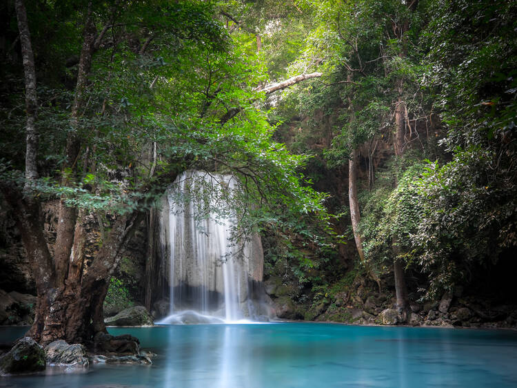 Swim in the multi-tiered Erawan Waterfalls