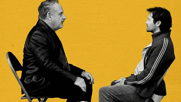 two men sitting and facing each other two men sitting and facing each other