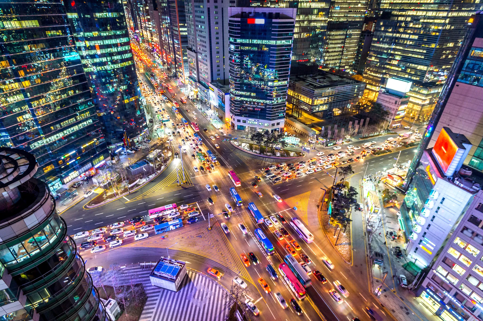 Traffic speeds through an intersection at night in Gangnam, Seoul in South Korea.