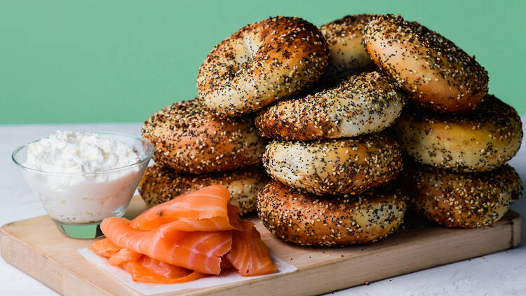 A wooden tray of bagels, schmear and locs