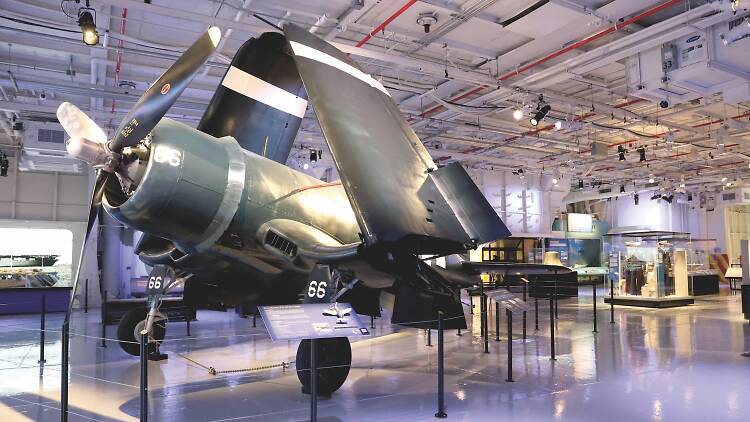 A WWII aircraft inside a museum exhibit.