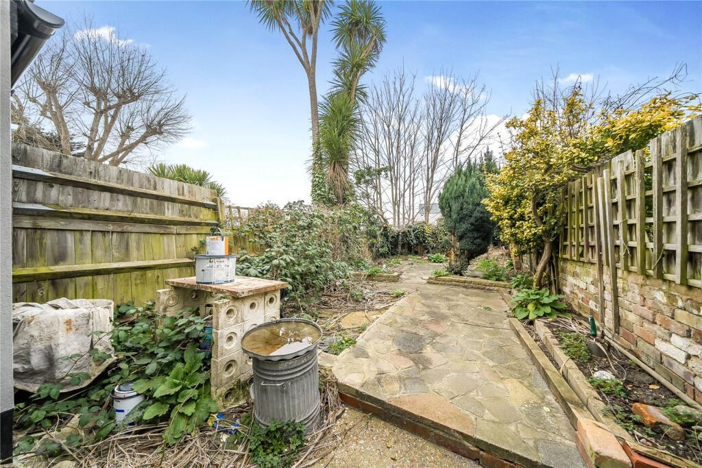 Overgrown paved garden in a terraced house in Bromley