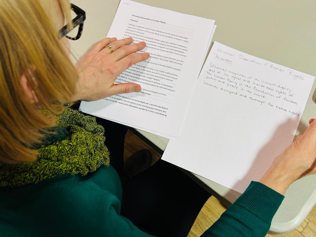 A woman writes down passages from the Constitution.