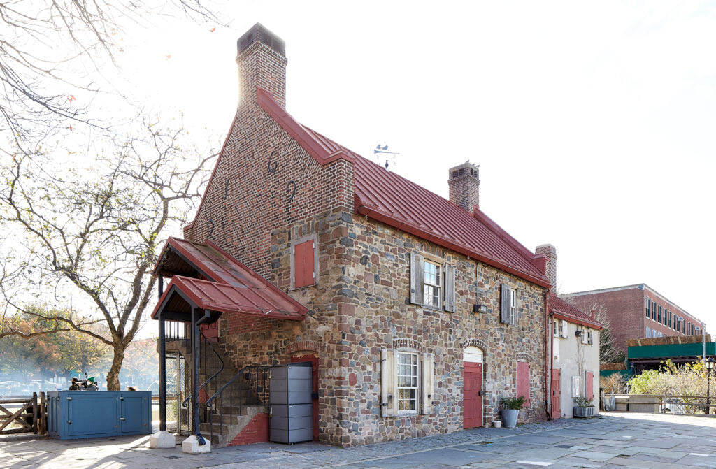 A stone house with a red roof.