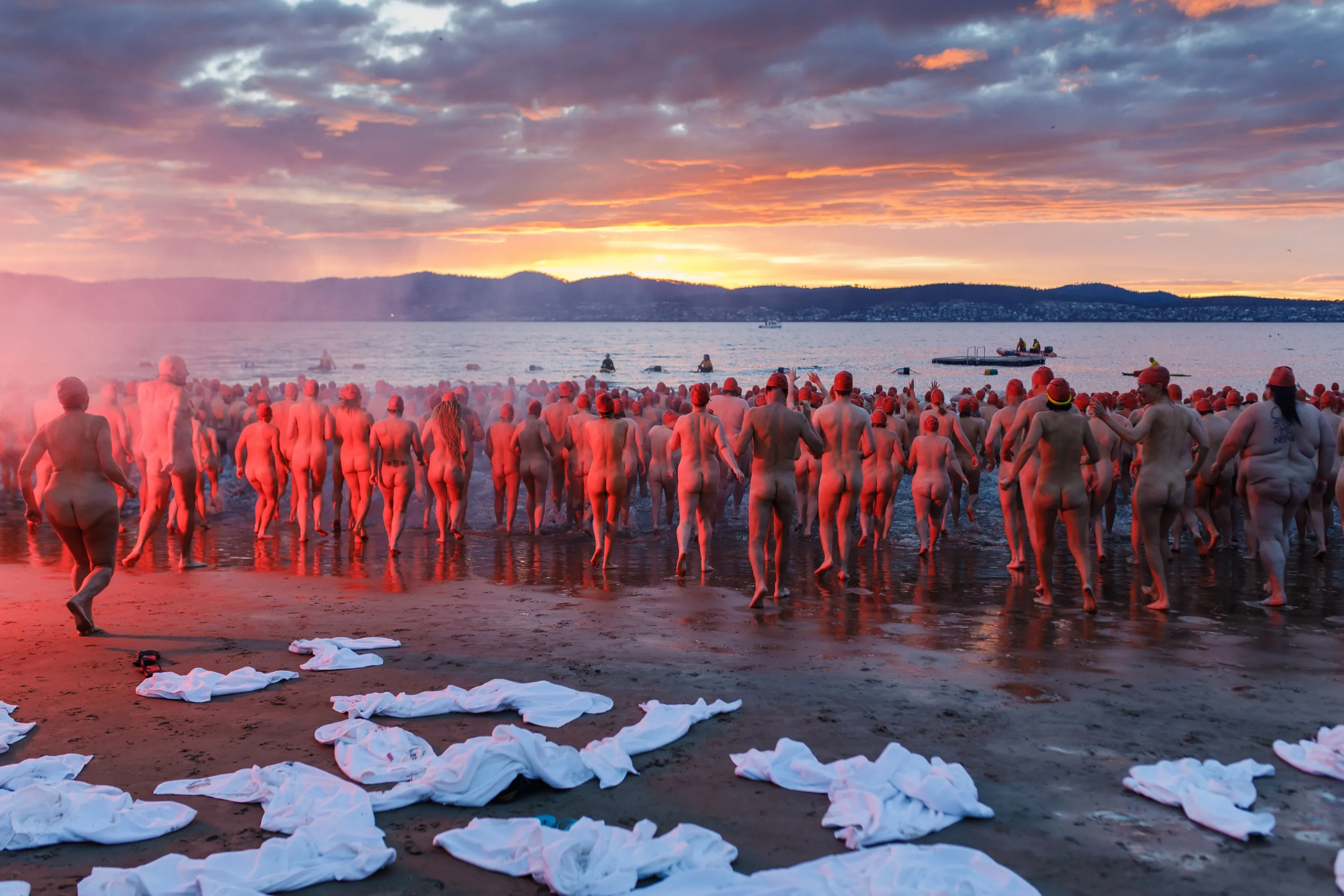 Nude people walking towards water