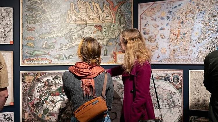 two people looking at map two people looking at map