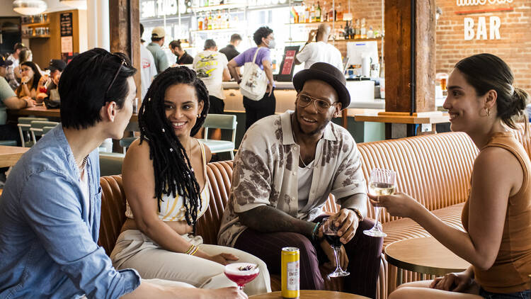 A group of friends sitting in the lounge at Time Out Market New York
