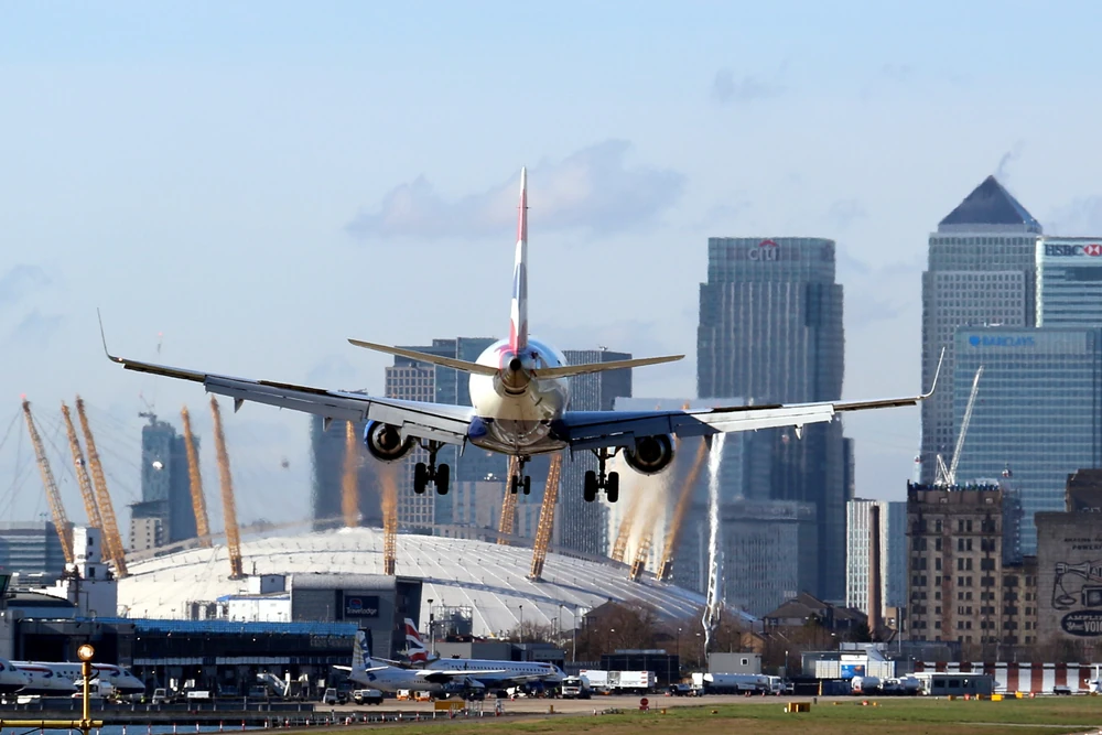 London City Airport with plane landing in front of the O2 Arena and Isle of Dogs