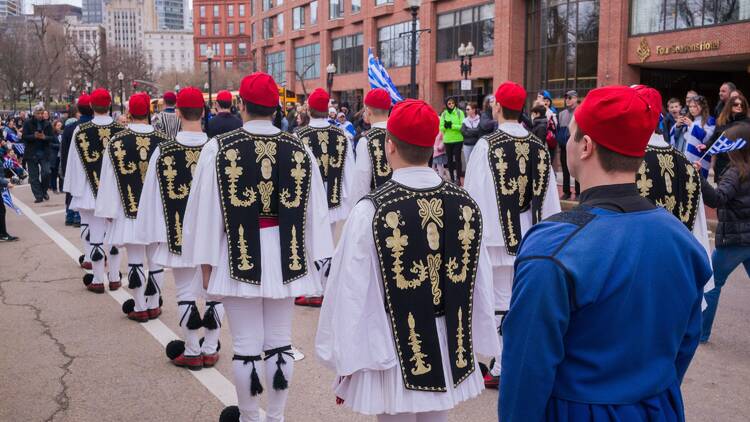 people in Greek traditional costumes walking in parade people in Greek traditional costumes walking in parade