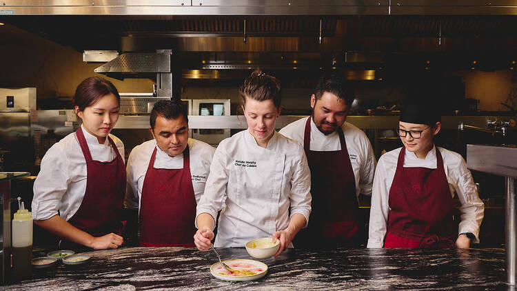 Chef Natalie Murphy in the Glass Brasserie kitchen with chefs