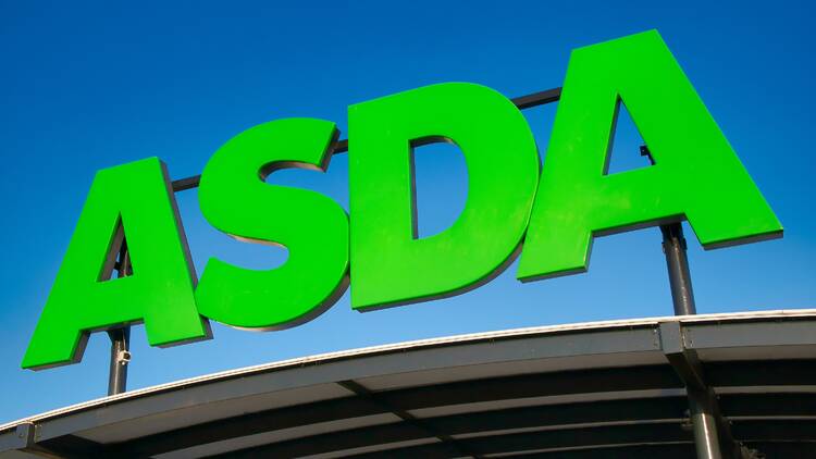 Asda logo against a blue sky in Wirral, England