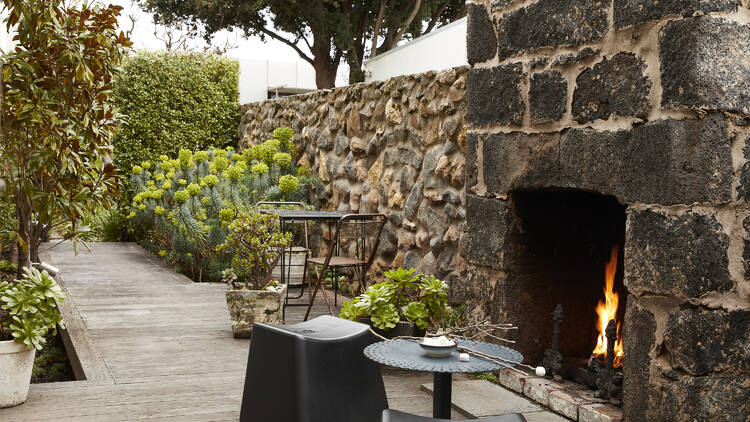 The outdoor courtyard and fireplace in suite three of Drift House.