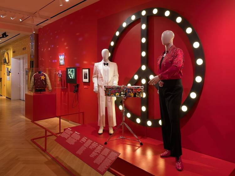 A museum exhibit showing two mannequins playing drums.