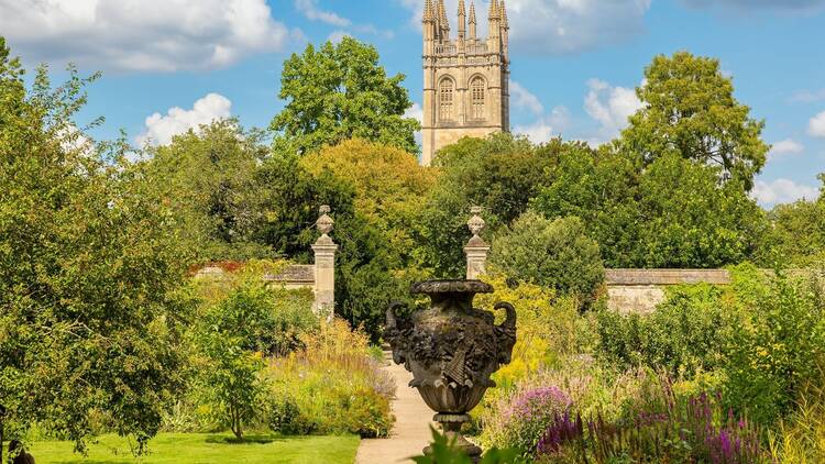 View to Oxford Botanic Garden with Magdalen Tower at distance. Oxford, England