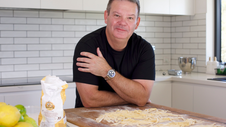 Gary Mehigan in the kitchen smiling for the camera.