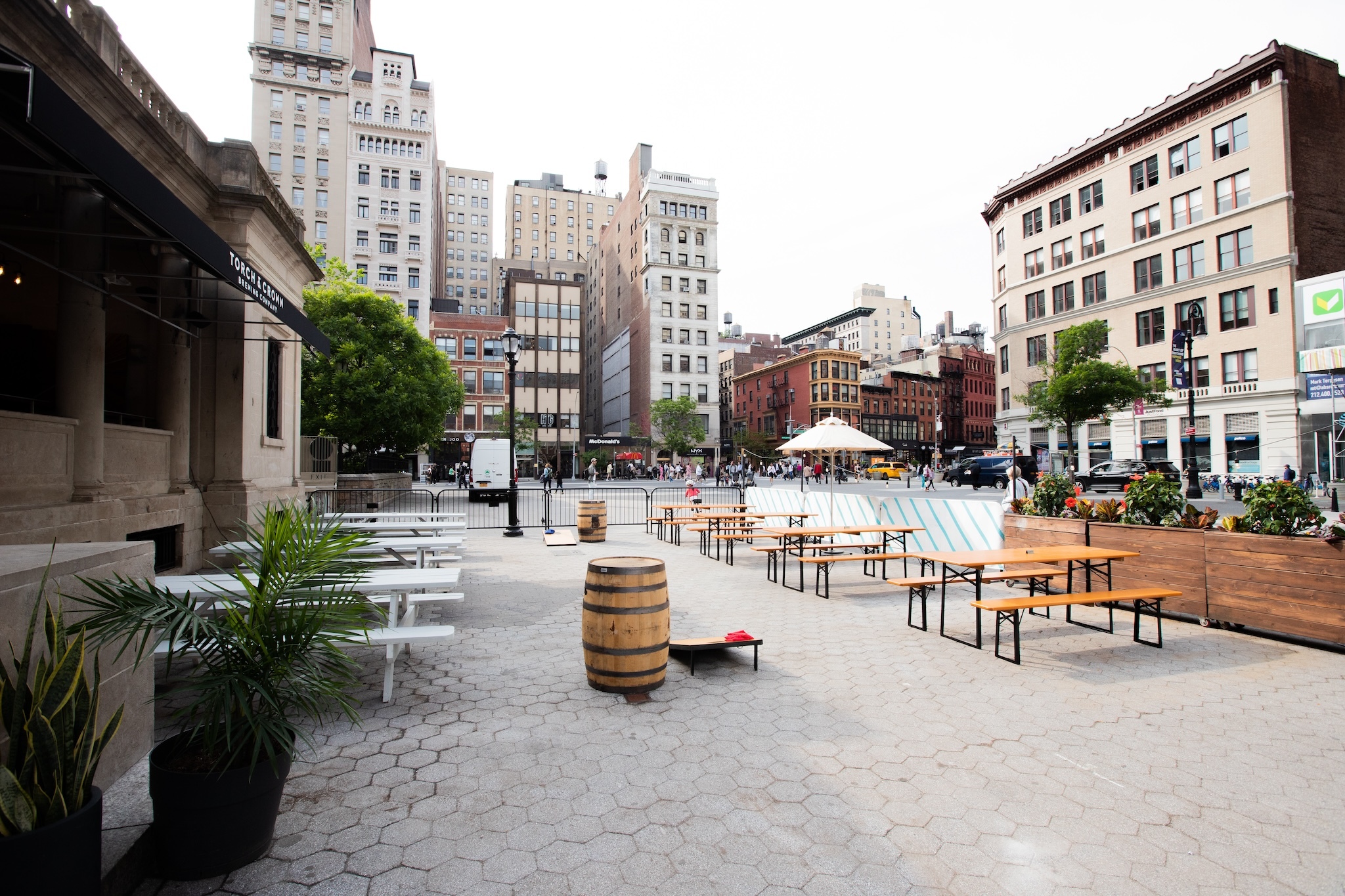 Outdoor patio with picnic tables and cornhole