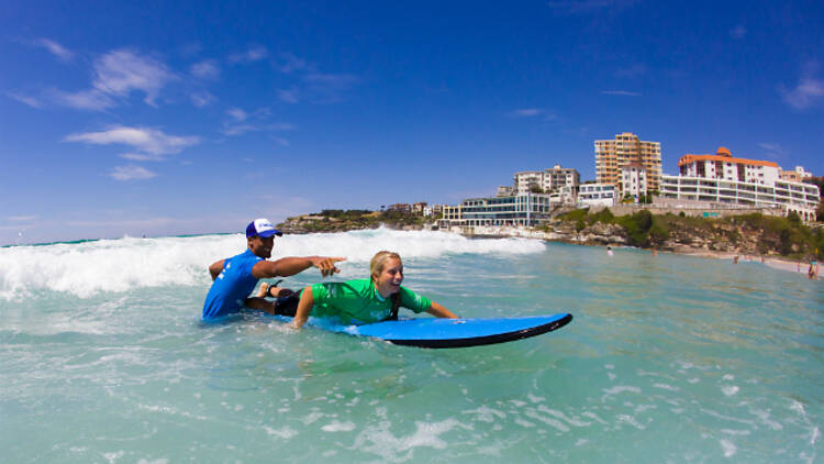 Kid taking surfing lesson