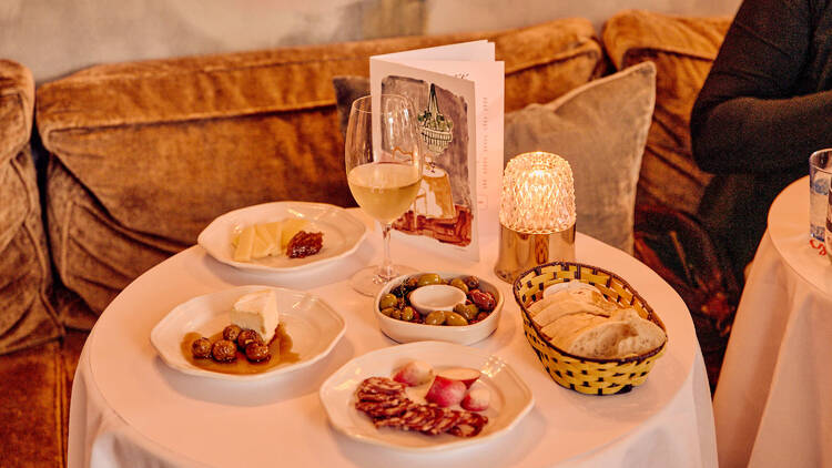 Assorted snacks and a glass of wine at Gigi.