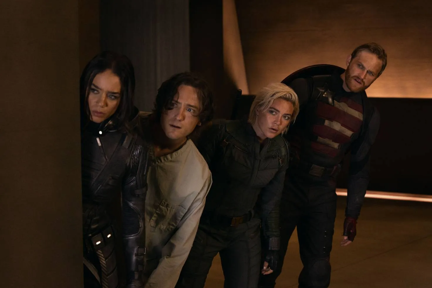 Members of the Thunderbolts huddled behind a wall