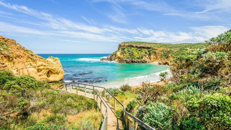 Path leading down to beautiful blue seas surrounded by lush greener