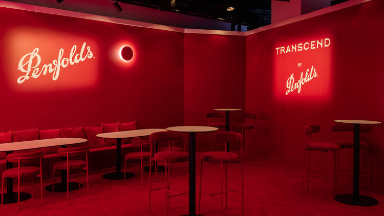 Red chairs and walls inside the pop-up Penfolds bar