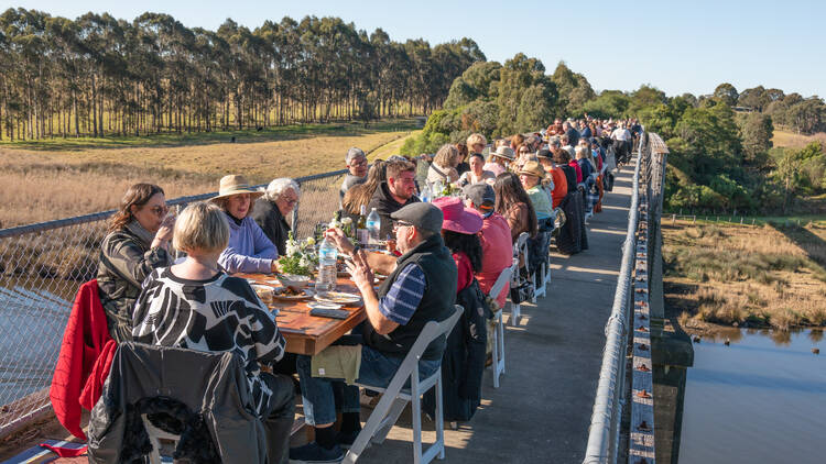Long tables lined up on Nicholson Trestle Bridge as part of the East Gippsland Winter Festival.