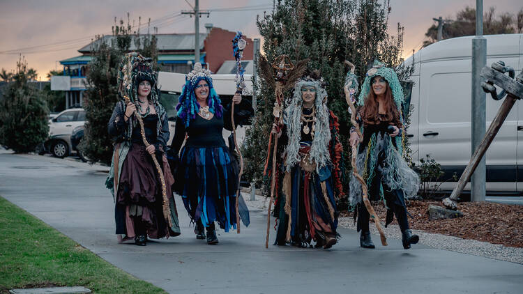 Four women dressed in witchy outfits as part of the East Gippsland Winter Festival.