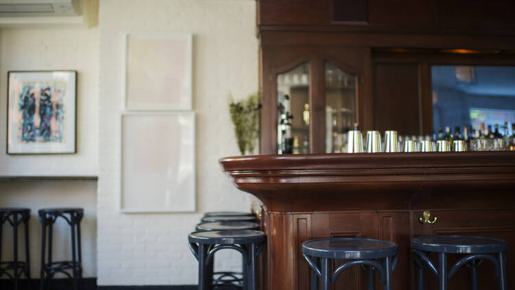 A wooden bar with white walls