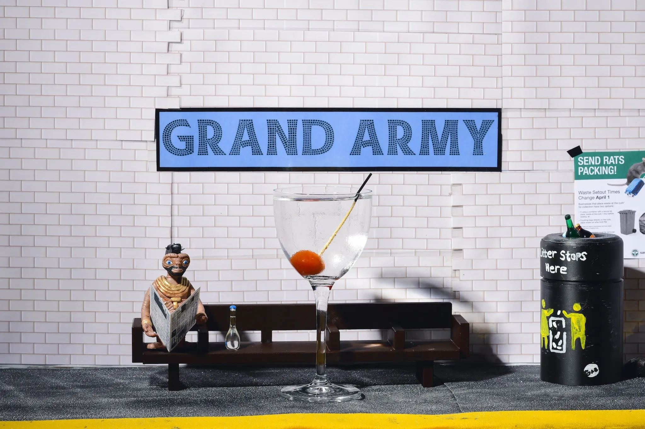 A martini glass in a diorama of the NYC subway system