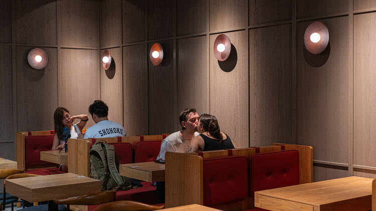 Guests sitting in diner-style booths at Ahma.