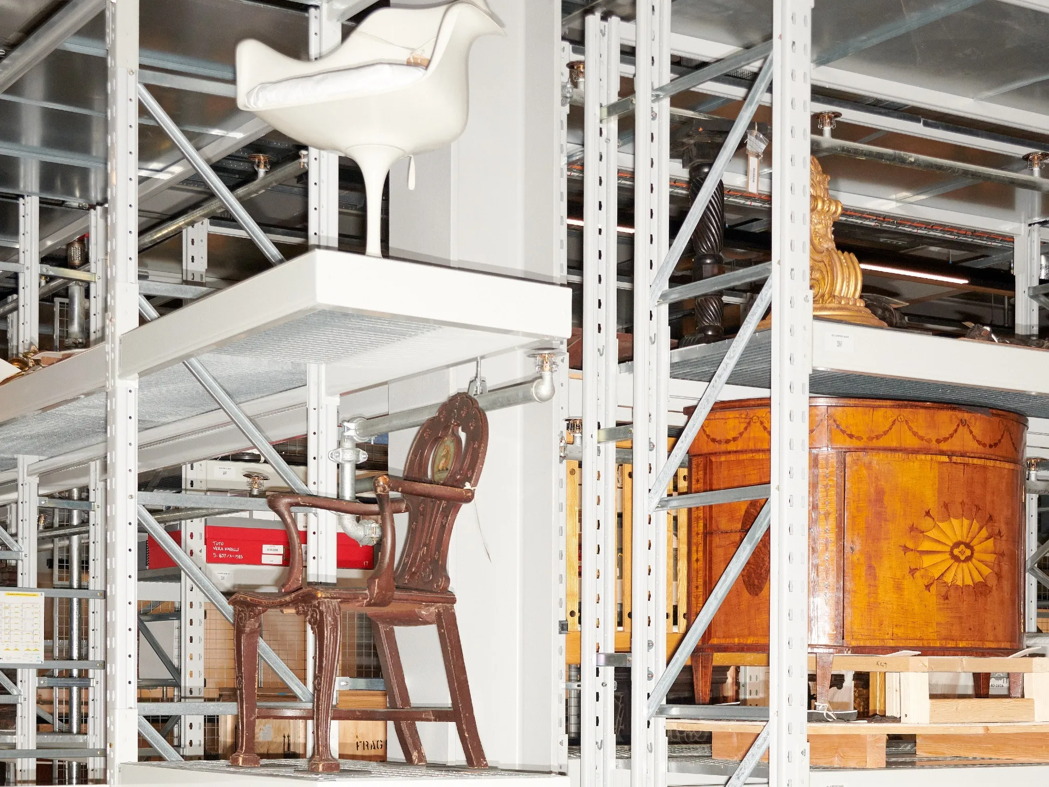 One of over 100 curated mini storage displays during install at V&A East Storehouse