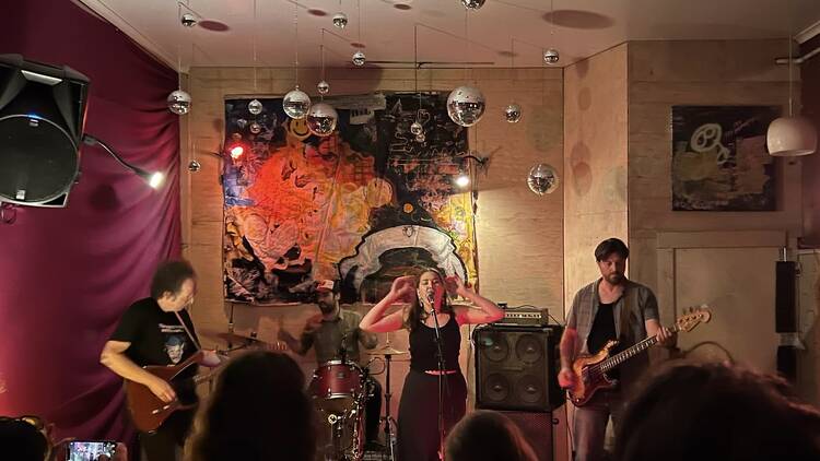 Ad Interim performing in a room with mirror balls.