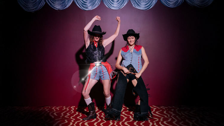 Members of Country Struts dancing in cowboy gear.