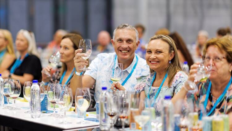 People tasting wine at the Good Food and Wine Show.