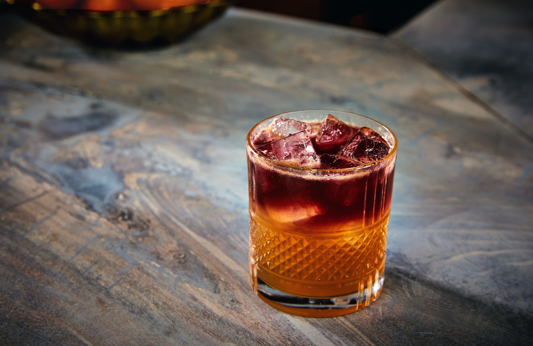 A cocktail with a red wine float