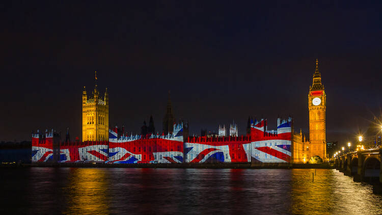 Houses of Parliament in London lit up with the Union Jack