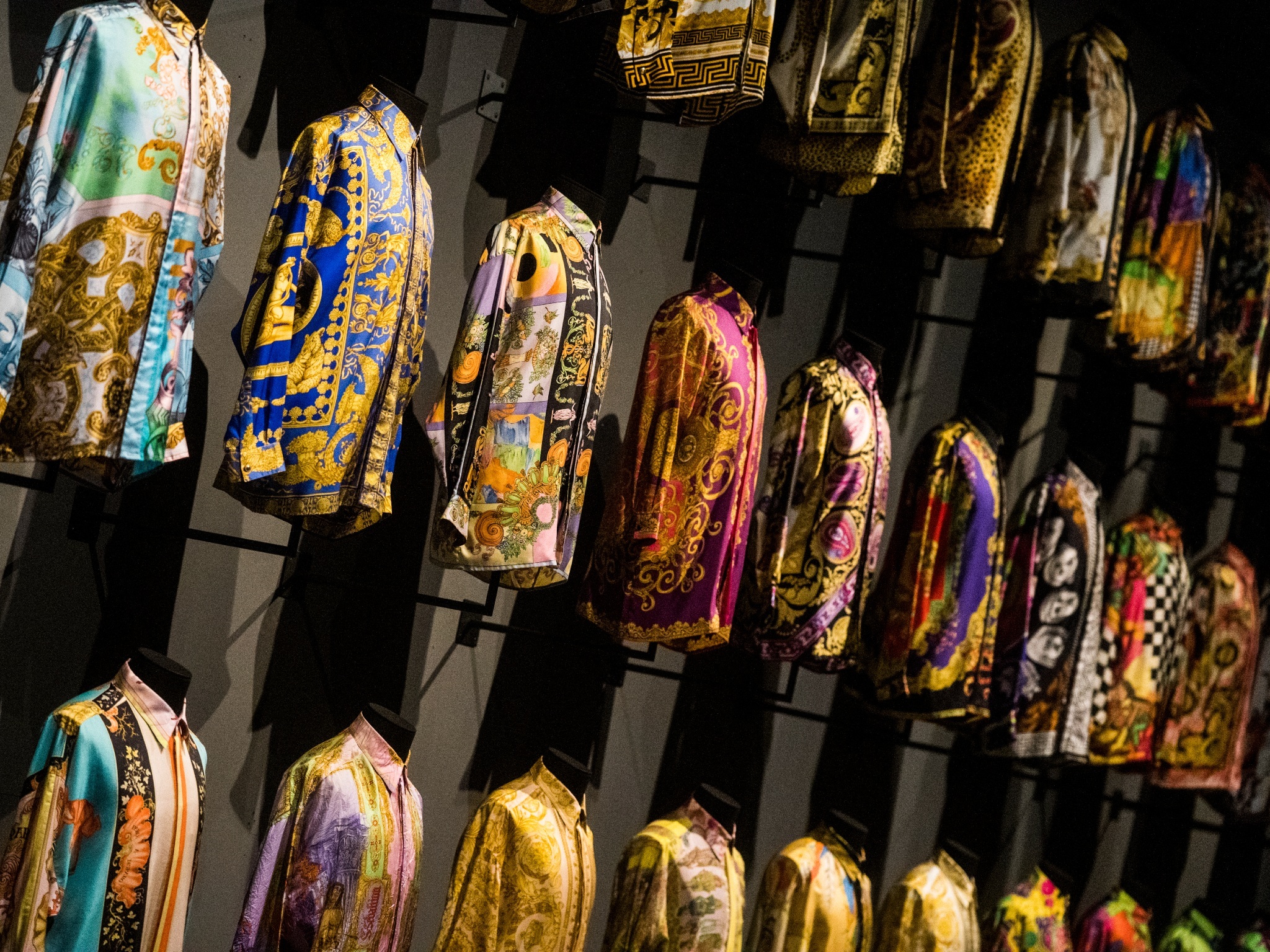 Three rows of Versace silk shirts displayed at Gianni Versace Retrospective exhibition