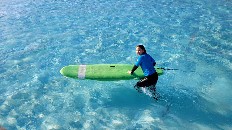 A woman with a foam board in a large pool
