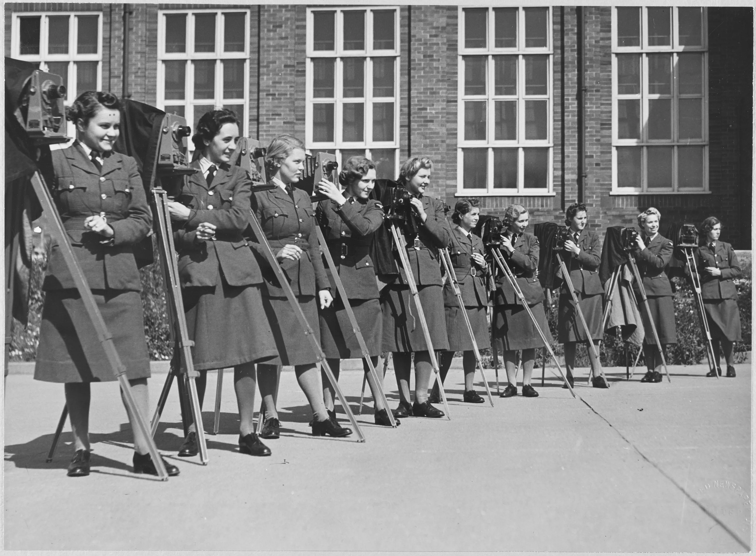 A group of women from the Women's Auxiliary Air Force with cameras