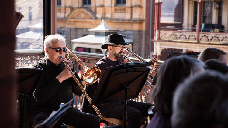 A brass band on a balcony. 