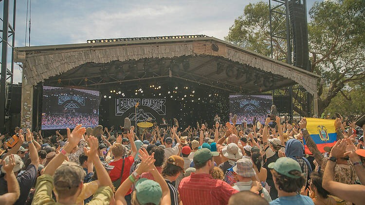 A crowd of people in front of a stage. 