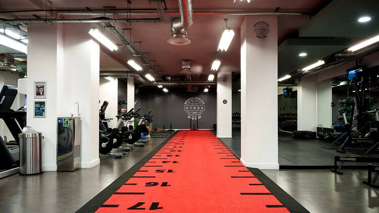 Interior of OneLDN Hyrox Gym showing sled push lane